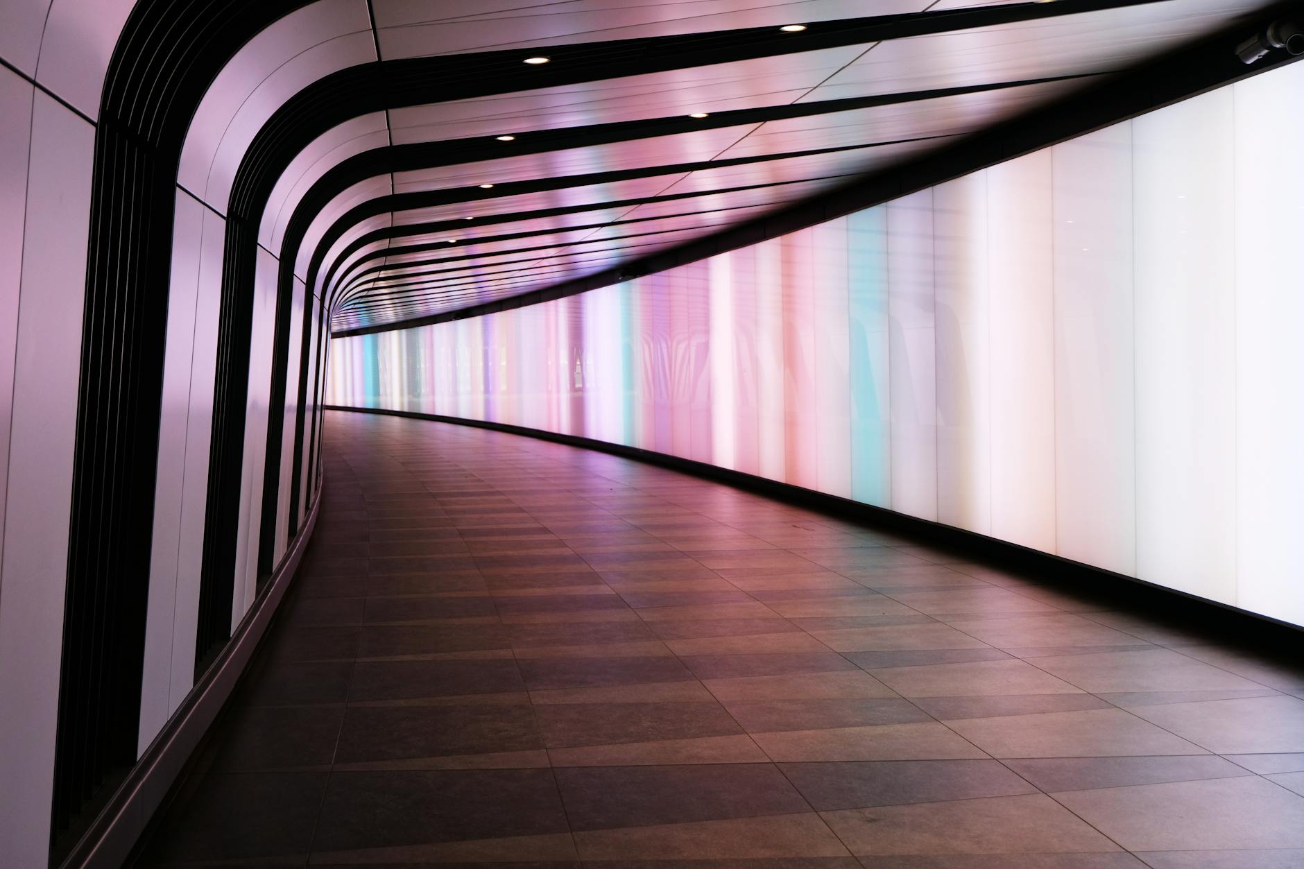 A mesmerizing futuristic tunnel with colorful lights and modern design in London.